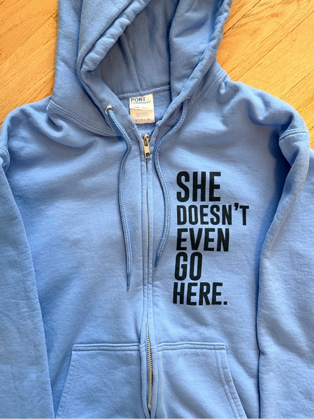 Light Blue Zip-Up Hoodie with 'She Doesn't Even Go Here' Text “Mean Girls”